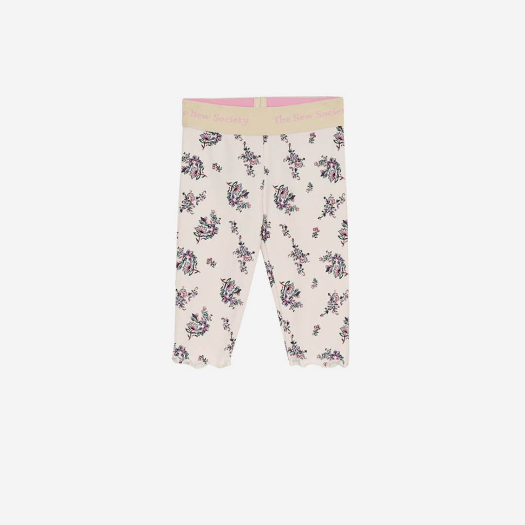 Sold at Bombon shop, these baby and toddler girl leggings by The New Society feature a soft cream base with an all-over floral print, a comfortable elastic waistband with logo detail, and a delicate lettuce-edge hem for a sweet everyday essential. front