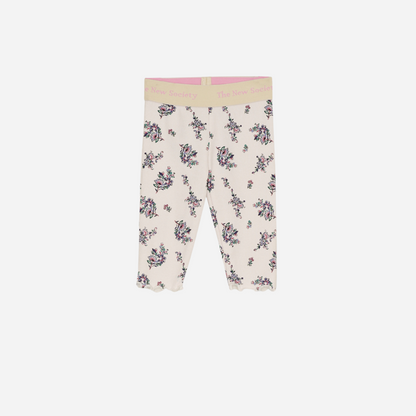 Sold at Bombon shop, these baby and toddler girl leggings by The New Society feature a soft cream base with an all-over floral print, a comfortable elastic waistband with logo detail, and a delicate lettuce-edge hem for a sweet everyday essential. front