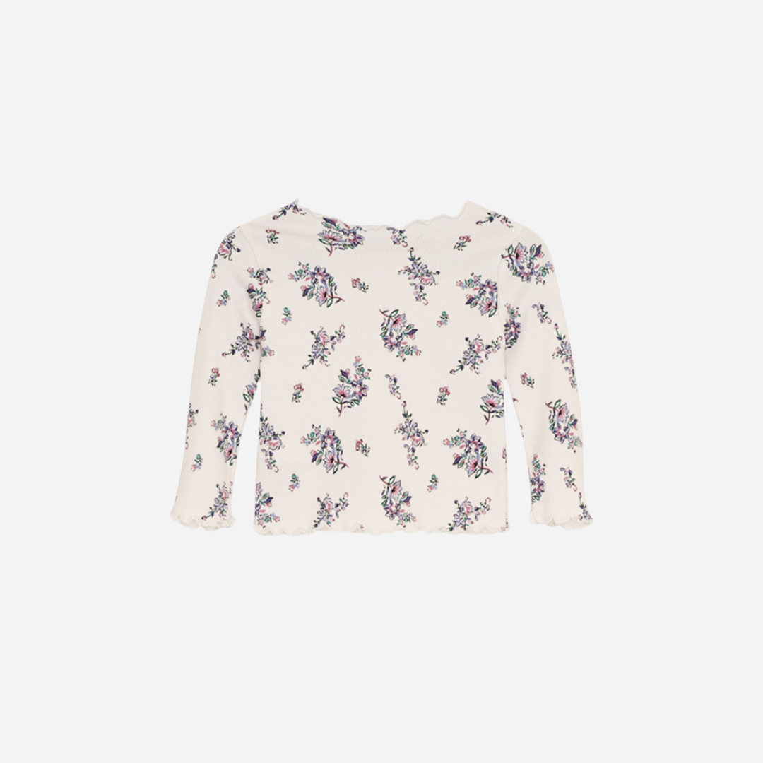 Sold at Bombon shop, this baby and toddler girl ribbed top by The New Society is adorned with a charming floral print and finished with a scalloped neckline and hem—perfect for layering or wearing on its own with matching bottoms. back