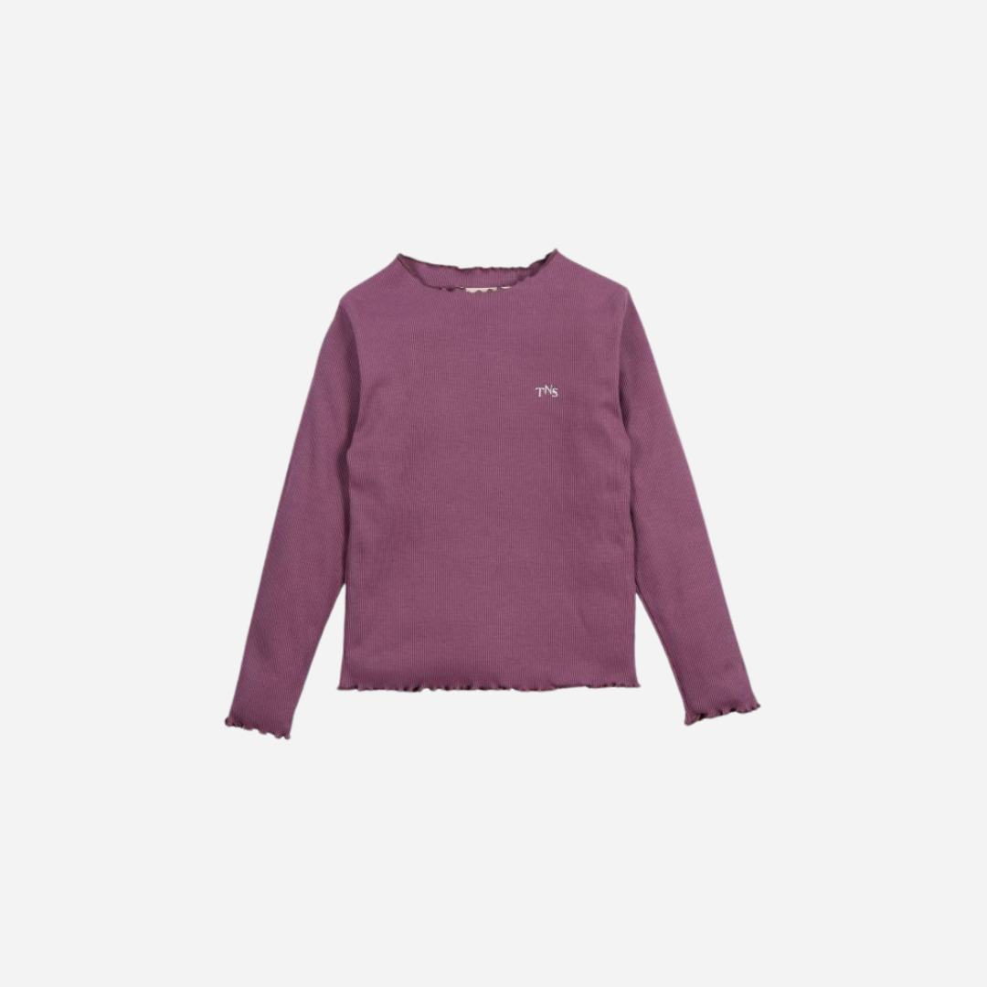 Sold at Bombon shop, this girls’ long-sleeve tee by The New Society comes in a soft violet ribbed fabric with delicate lettuce-edge hems and a small “TNS” embroidered logo on the chest—perfect for layering or wearing on its own. front