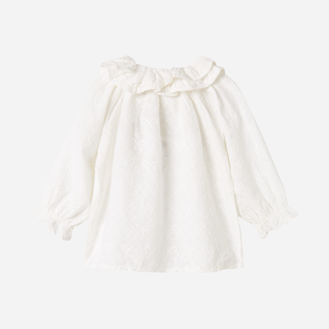 Sold at Bombon shop, designed by MarMar Copenhagen — cream 100% cotton baby blouse with ruffled collar and frilled cuff