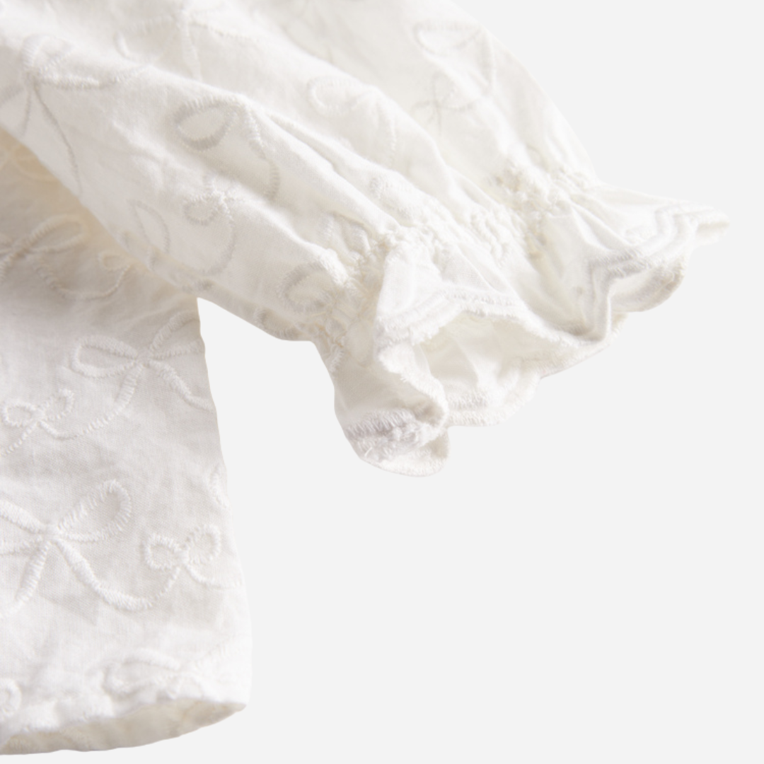 Sold at Bombon shop, designed by MarMar Copenhagen — cream 100% cotton baby blouse with ruffled collar and frilled cuff
