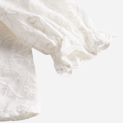 Sold at Bombon shop, designed by MarMar Copenhagen — cream 100% cotton baby blouse with ruffled collar and frilled cuff