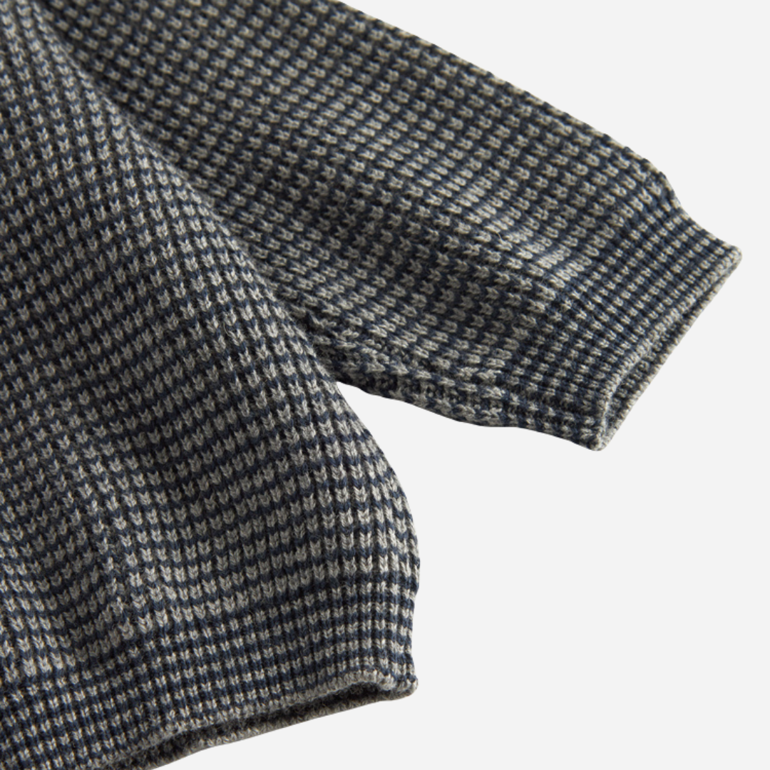 Sold at Bombon shop, designed by MarMar Copenhagen. Blue and beige textured knit baby sweater with shoulder buttons, pairs perfectly with the matching knit pants.