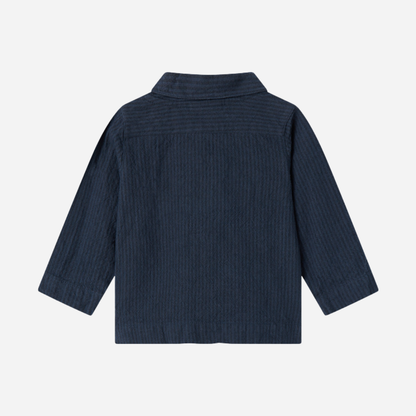 Sold at Bombon shop, designed by MarMar Copenhagen — navy 100% cotton textured long-sleeve baby shirt with buttons, part of a matching set