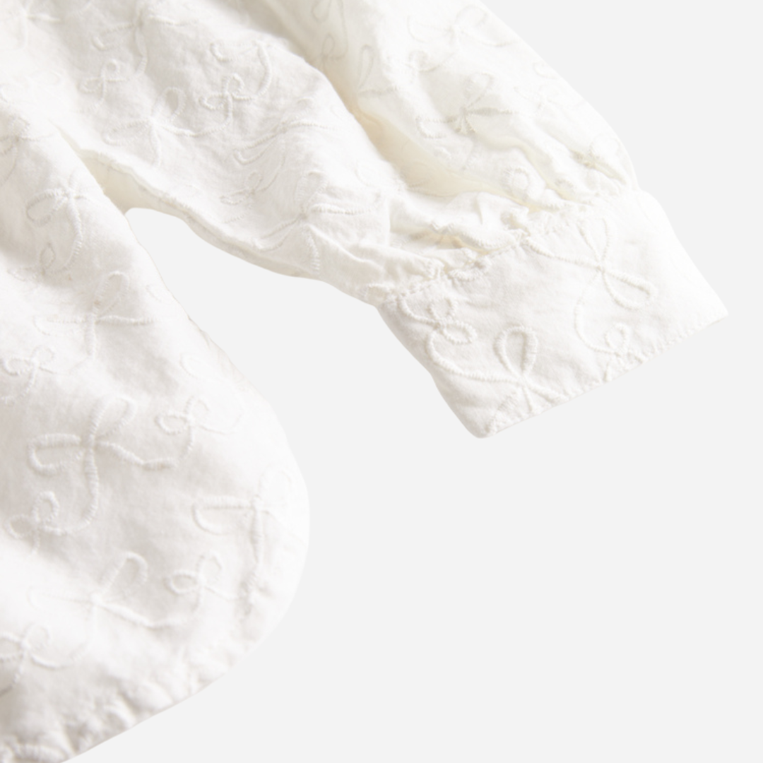 Sold at Bombon shop, designed by MarMar Copenhagen — cream 100% cotton baby blouse with rounded collar and gathered details, pairs perfectly with the navy pinafore dress.