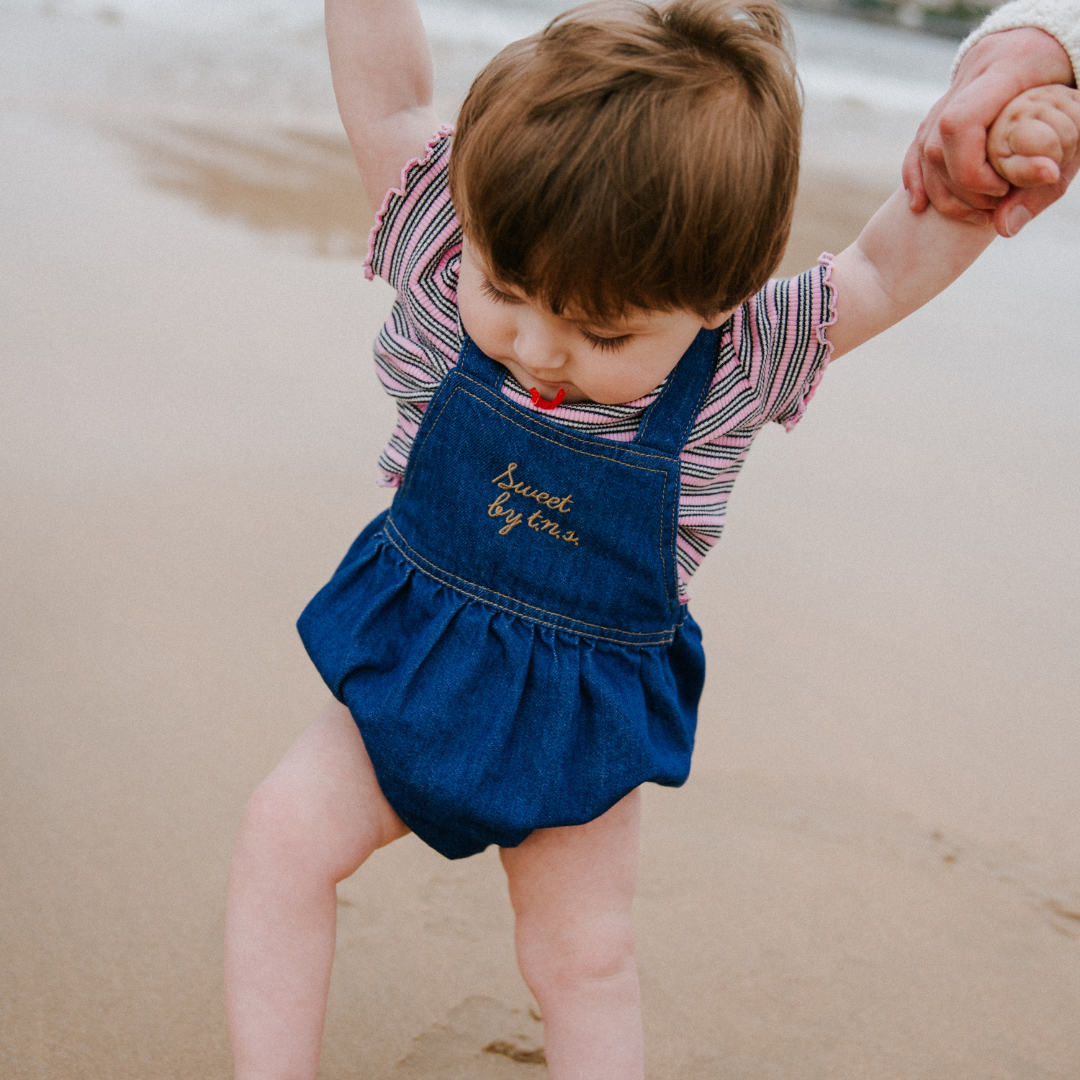 sold at Bombon, designed by The New Society blue denim baby romper in 100% cotton with classic silhouette and everyday wear style