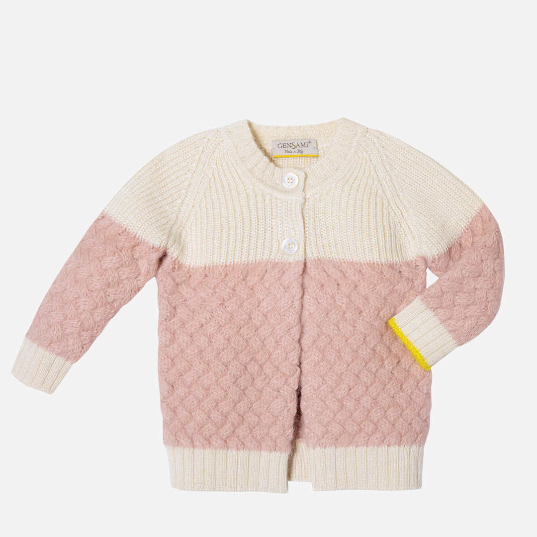 Sold at Bombon and designed by Gensami, a baby cardigan with a cream and pink color block knit pattern, textured detailing, front buttons, and a yellow trim accent on the cuff.