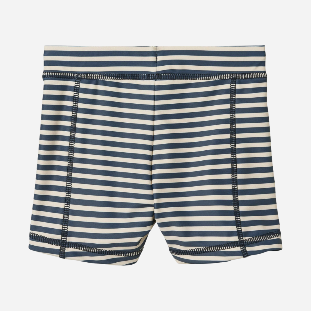 Sold at Bombon Shop, designed by Wheat, blue stripe swim shorts in recycled fabric with navy and light blue horizontal stripes and drawstring waistband.