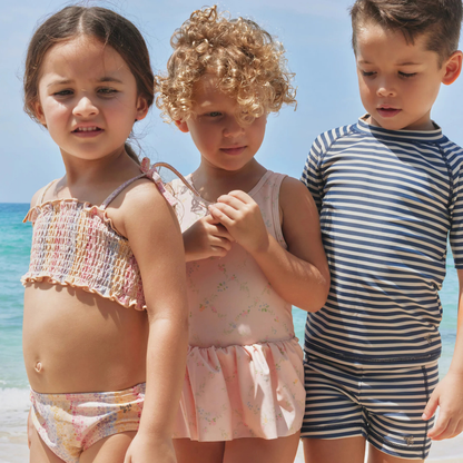 Sold at Bombon Shop, designed by Wheat, blue stripe swim shorts in recycled fabric with navy and light blue horizontal stripes and drawstring waistband.