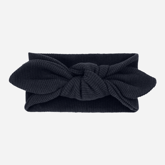 Sold at Bombon shop, designed by 1+ in the family – Ursula headband in navy blue with ribbed cotton texture and knotted bow detail.