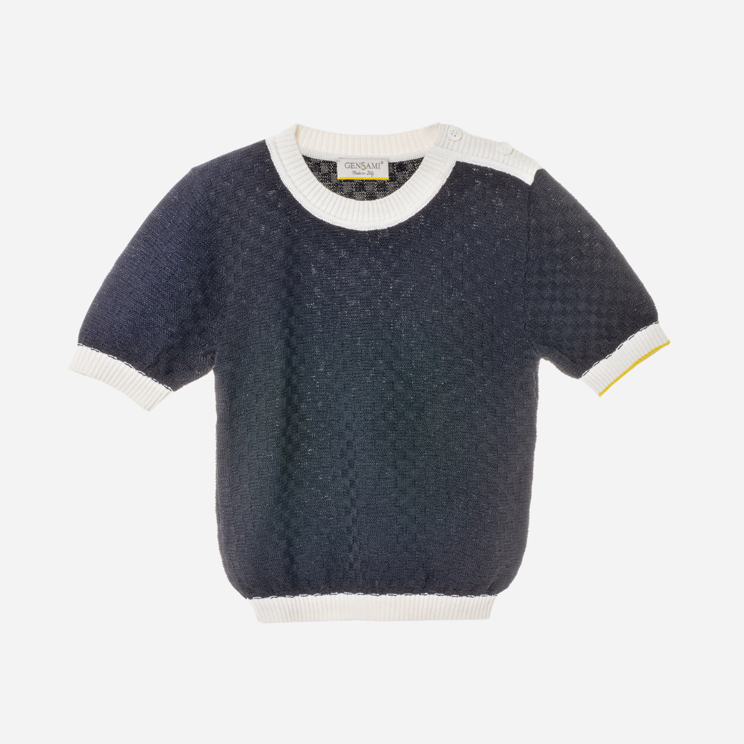 Sold at Bombon and designed by Gensami, a navy blue short-sleeve knit baby sweater with white ribbed trim at the collar, sleeves, and hem, featuring a yellow accent on one cuff.