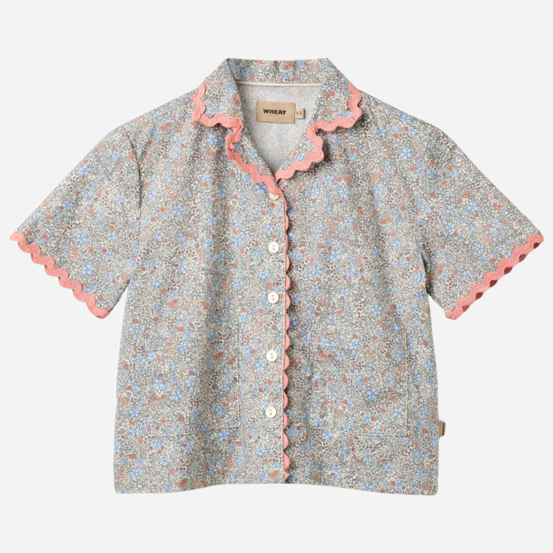 Sold at Bombon Shop, designed by Wheat, air blue flowers organic cotton short sleeve blouse with lace trim and soft blue floral print.
