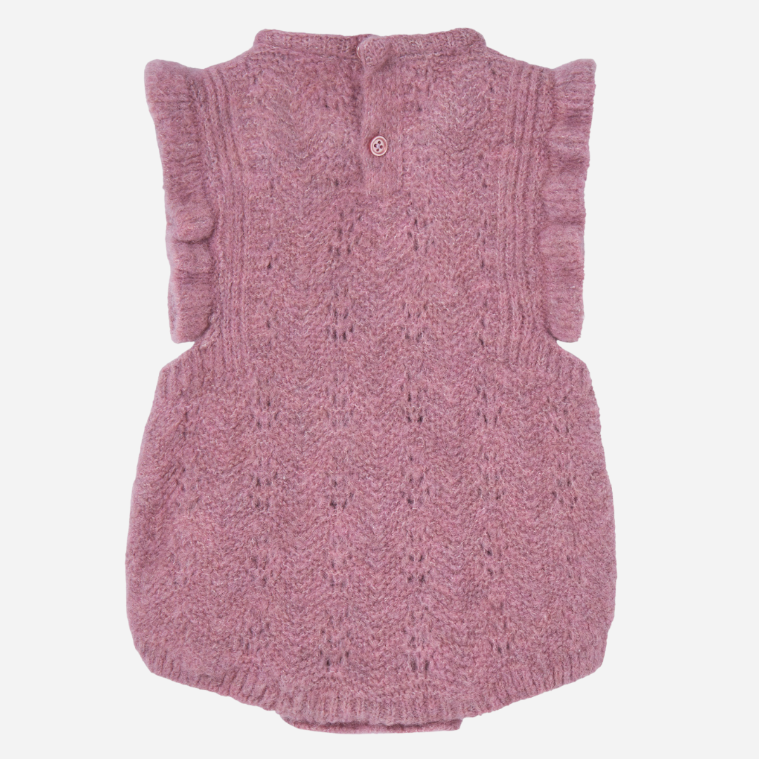 Sold at Bombon shop, designed by Paz Rodriguez, dusty rose knit baby romper with ruffled sleeves and openwork details