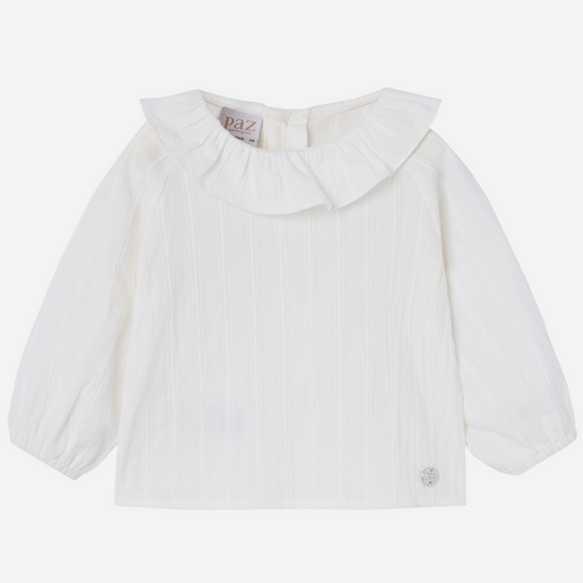 Sold at Bombon shop, designed by Paz Rodriguez, white baby blouse with ruffled collar and puffed sleeves.