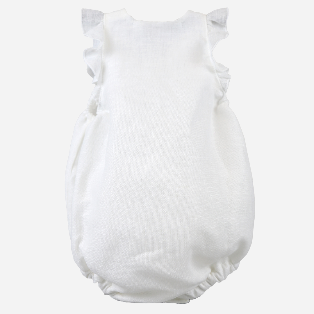 sold at Bombon shop, designed by al agua patos brand, this white linen romper for baby girls is ideal for spring and summer. back view
