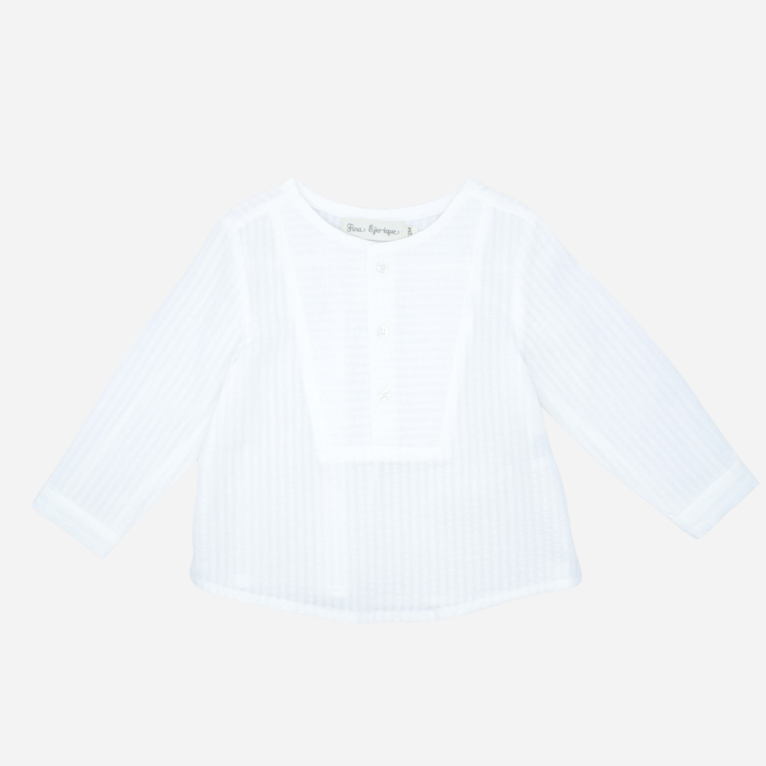 Sold at Bombon shop, designed by Fina Ejerique brand, white long sleeve bib shirt for babies and toddlers is perfect for spring and summer. Front view
