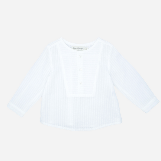 Sold at Bombon shop, designed by Fina Ejerique brand, white long sleeve bib shirt for babies and toddlers is perfect for spring and summer. Front view