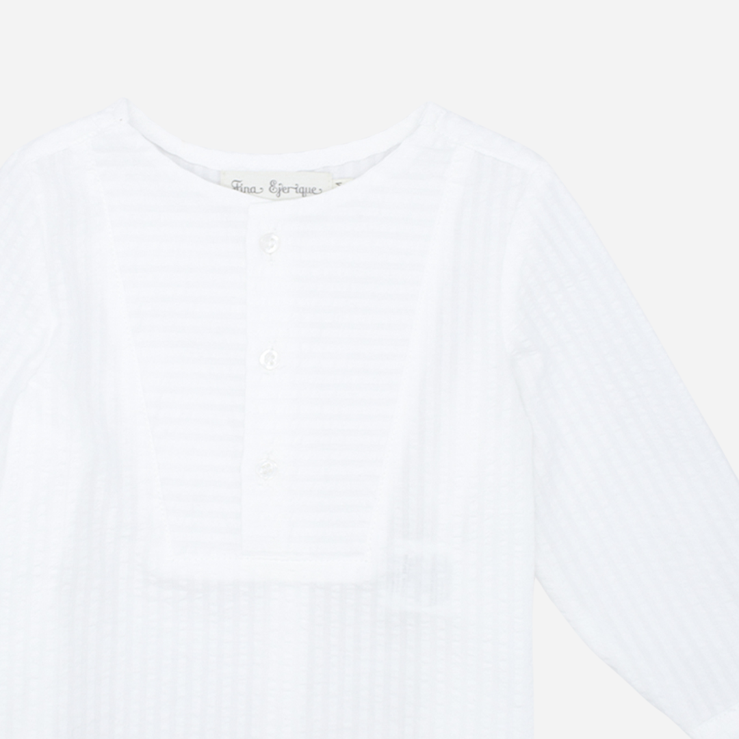 Sold at Bombon shop, designed by Fina Ejerique brand, white long sleeve bib shirt for babies and toddlers is perfect for spring and summer. Zoom view