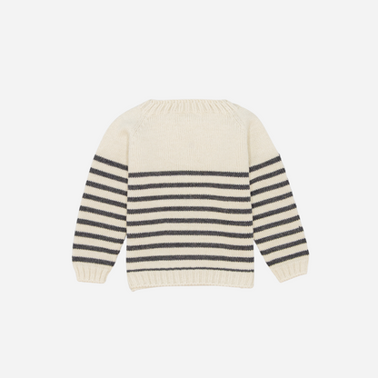 Sold at Bombon shop, designed by Fina Ejerique, a cream knit baby sweater with gray horizontal stripes, styled to pair with grey twill trousers. back