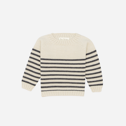 Sold at Bombon shop, designed by Fina Ejerique, a cream knit baby sweater with gray horizontal stripes, styled to pair with grey twill trousers. front