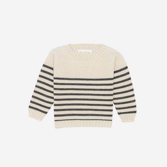 Sold at Bombon shop, designed by Fina Ejerique, a cream knit baby sweater with gray horizontal stripes, styled to pair with grey twill trousers. front