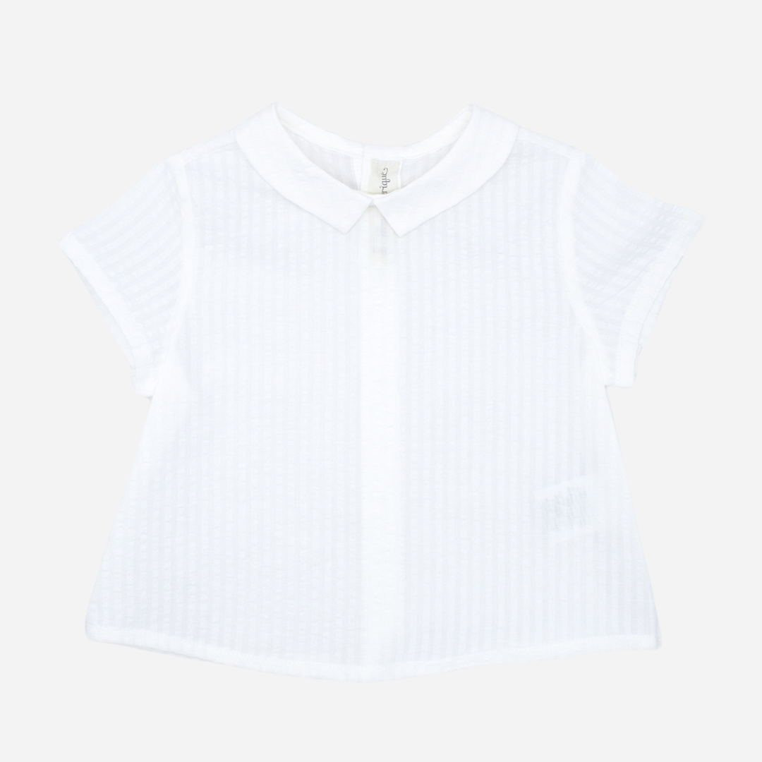 Sold at Bombon shop, designed by Fina Ejerique brand, white short sleeved baby shirt perfect for spring and summer. Front view. 