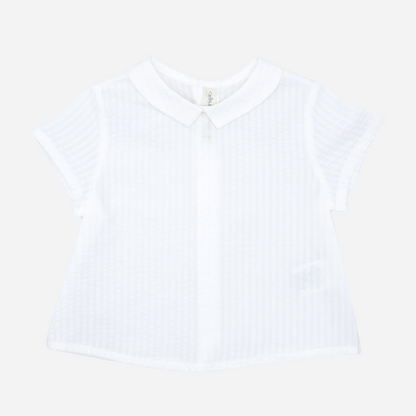 Sold at Bombon shop, designed by Fina Ejerique brand, white short sleeved baby shirt perfect for spring and summer. Front view. 