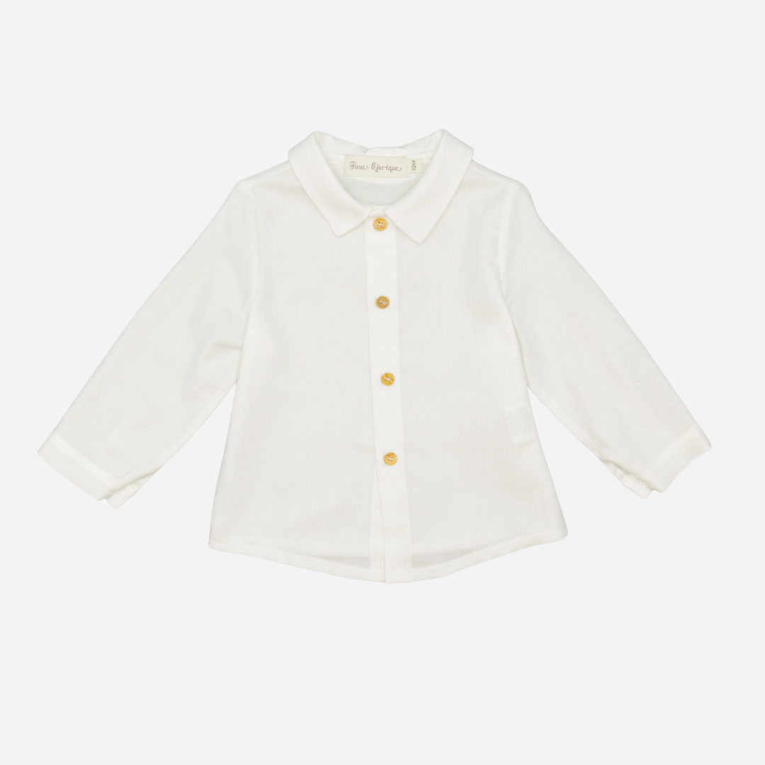 Sold at Bombon shop, designed by Fina Ejerique, a white viyella baby shirt with rounded collar, wooden buttons, and long sleeves. front