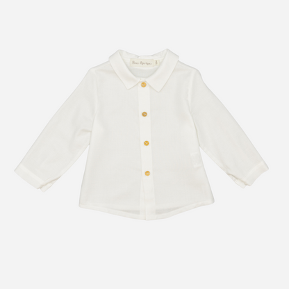 Sold at Bombon shop, designed by Fina Ejerique, a white viyella baby shirt with rounded collar, wooden buttons, and long sleeves. front