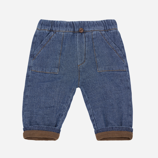 Sold at Bombon shop, designed by 1+ in the family – William baby pants in soft denim with front pockets, elastic waistband, and brown fleece-lined cuffs. front