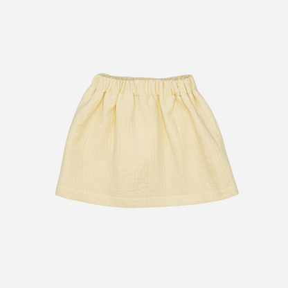 Sold at Bombon shop, designed by Fina Ejerique, beige textured skirt with button front and scalloped pockets, pairs perfectly with the floral blouse and pink vest. back