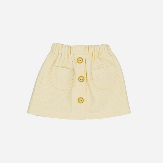 Sold at Bombon shop, designed by Fina Ejerique, beige textured skirt with button front and scalloped pockets, pairs perfectly with the floral blouse and pink vest. front