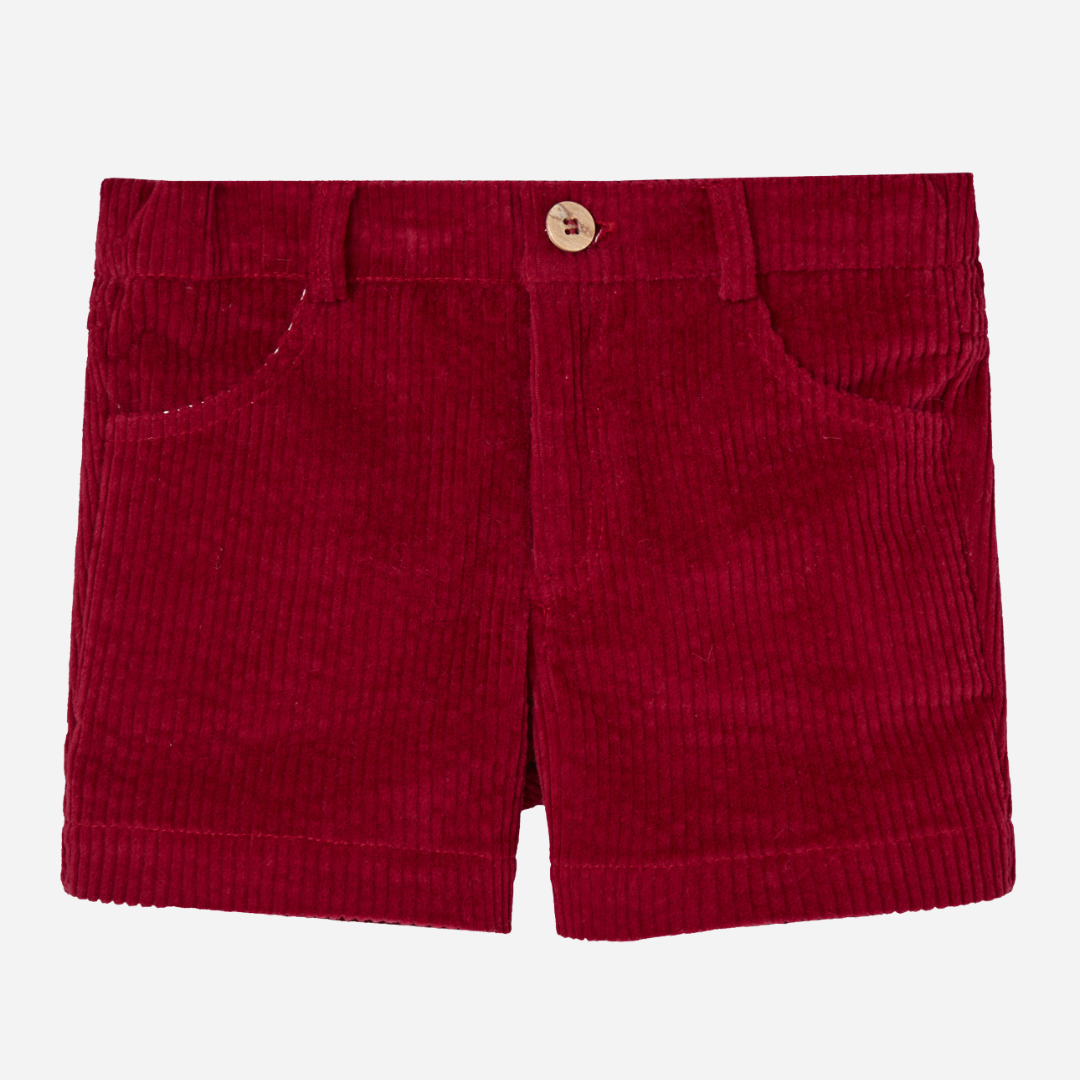 Sold at Bombon shop, designed by Paz Rodriguez, red corduroy boys' shorts with front pockets and wooden button