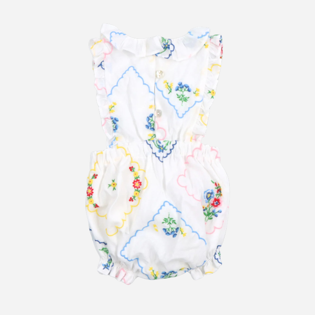 sold at Bombon, designed by The New Society baby romper with multicolor floral embroidery on soft cotton with ruffle details matching sibling set
