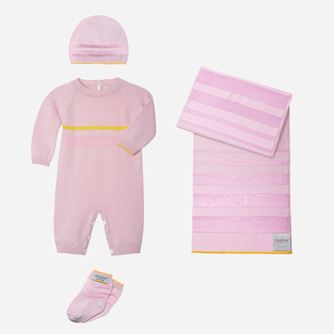 Sold at Bombon and designed by Gensami, a pink newborn layette set featuring a knit jumpsuit, hat, socks, and matching blanket with yellow stripe accents