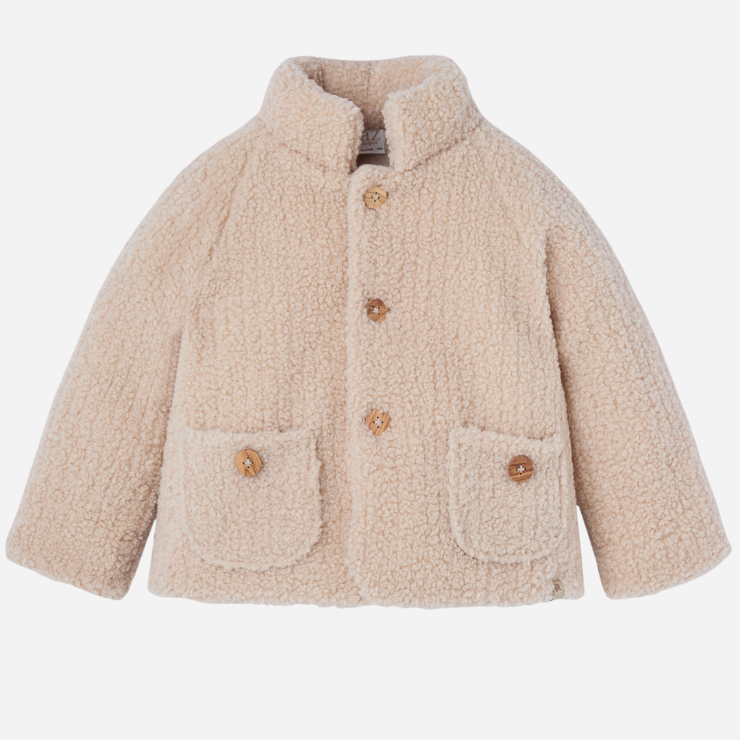 Sold at Bombon shop, designed by Paz Rodriguez, cream sherpa-style baby jacket with wooden buttons and front patch pockets