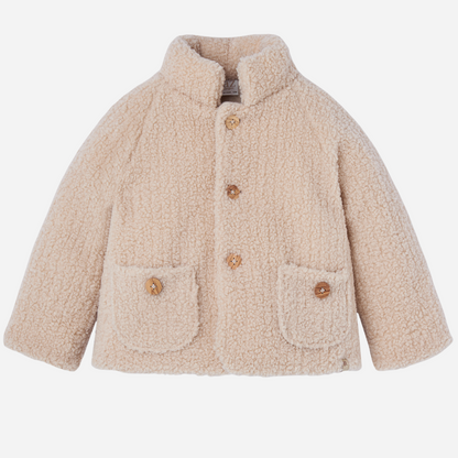 Sold at Bombon shop, designed by Paz Rodriguez, cream sherpa-style baby jacket with wooden buttons and front patch pockets